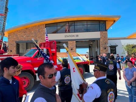 Community ceremony at Fire Station 5B with flags and veterans