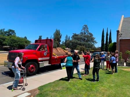 Community gathering around the memorial beam