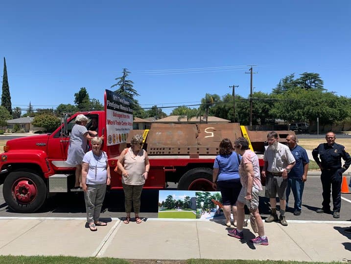 Community viewing the memorial beam